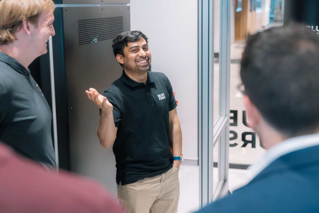Bluefors employee smiling in the lab space at the Bluefors lab opening event.