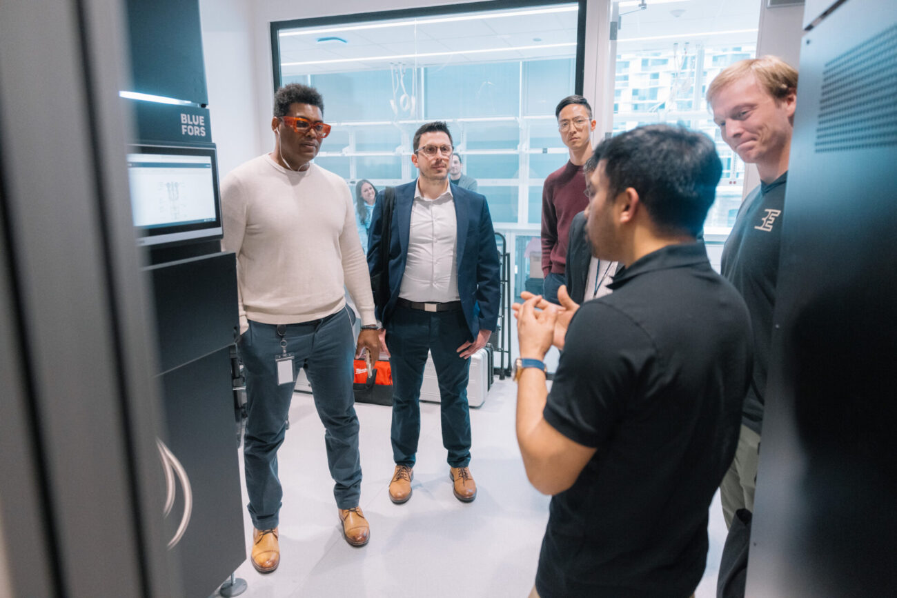 People discussing in a lab space at the Bluefors Lab opening event.