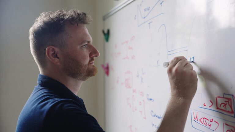 Researcher working on a whiteboard